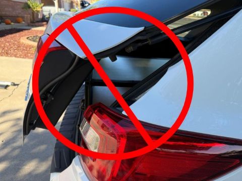 rear car door hatch colliding with SUV drawer