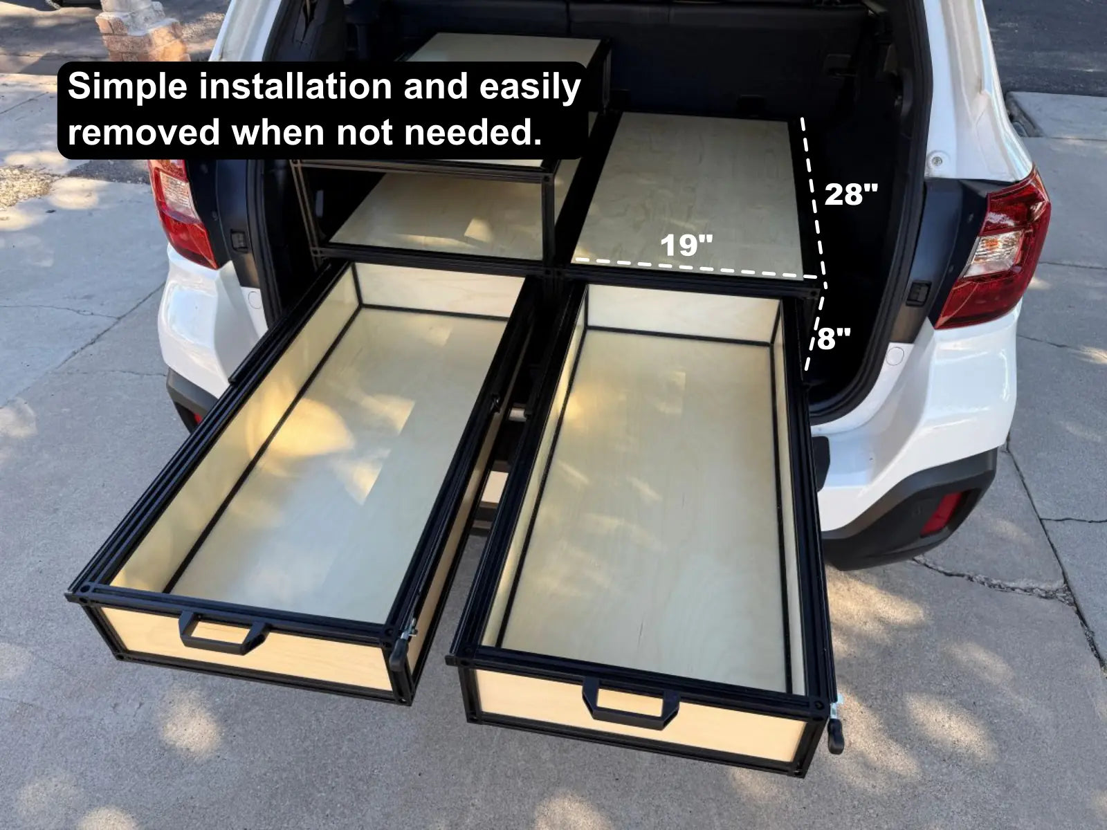 two drawers and shelf inside the back of a SUV