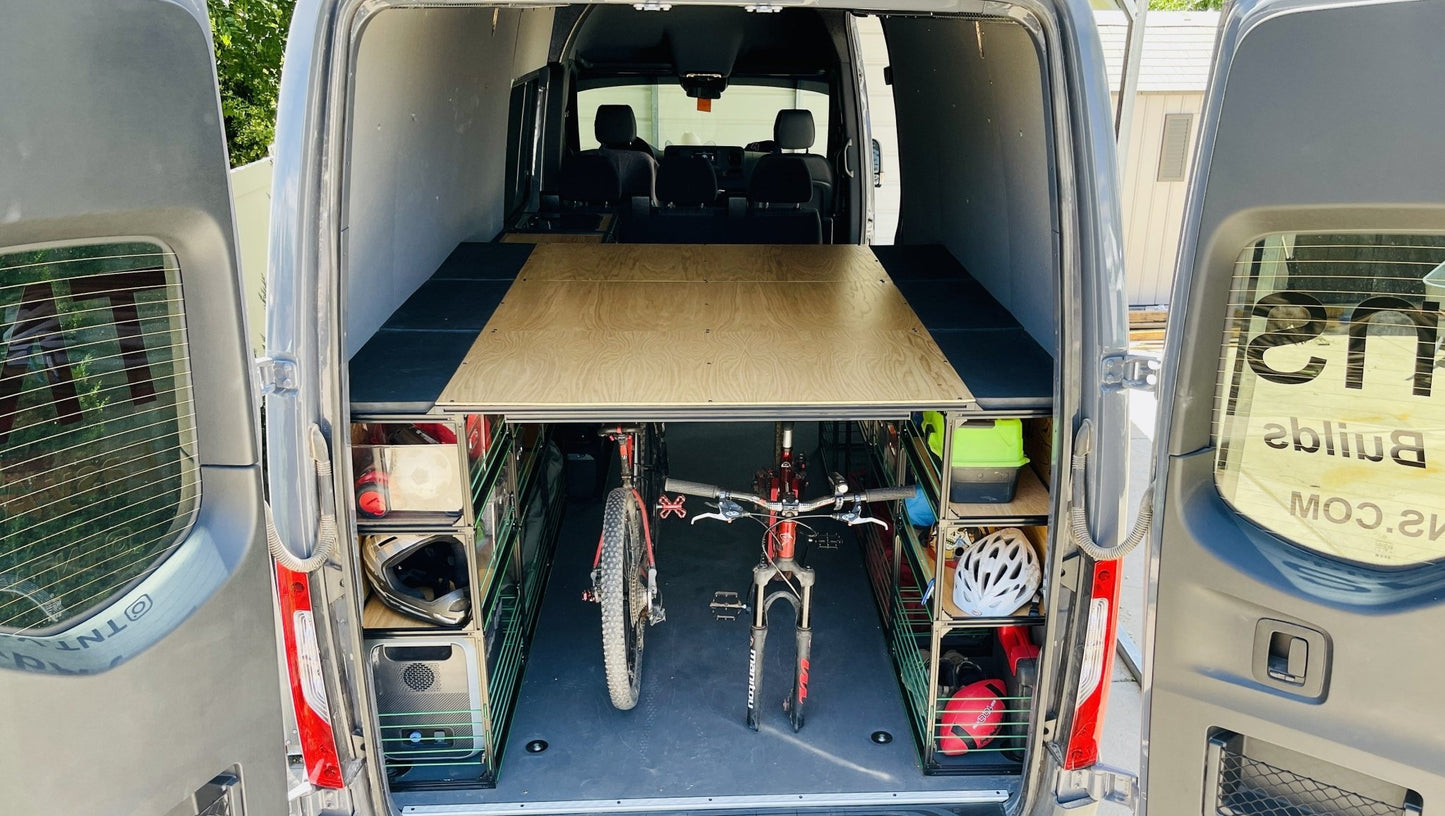 Van bed system with two bicycles in the middle.